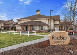 River View Apartments office building and rock sign